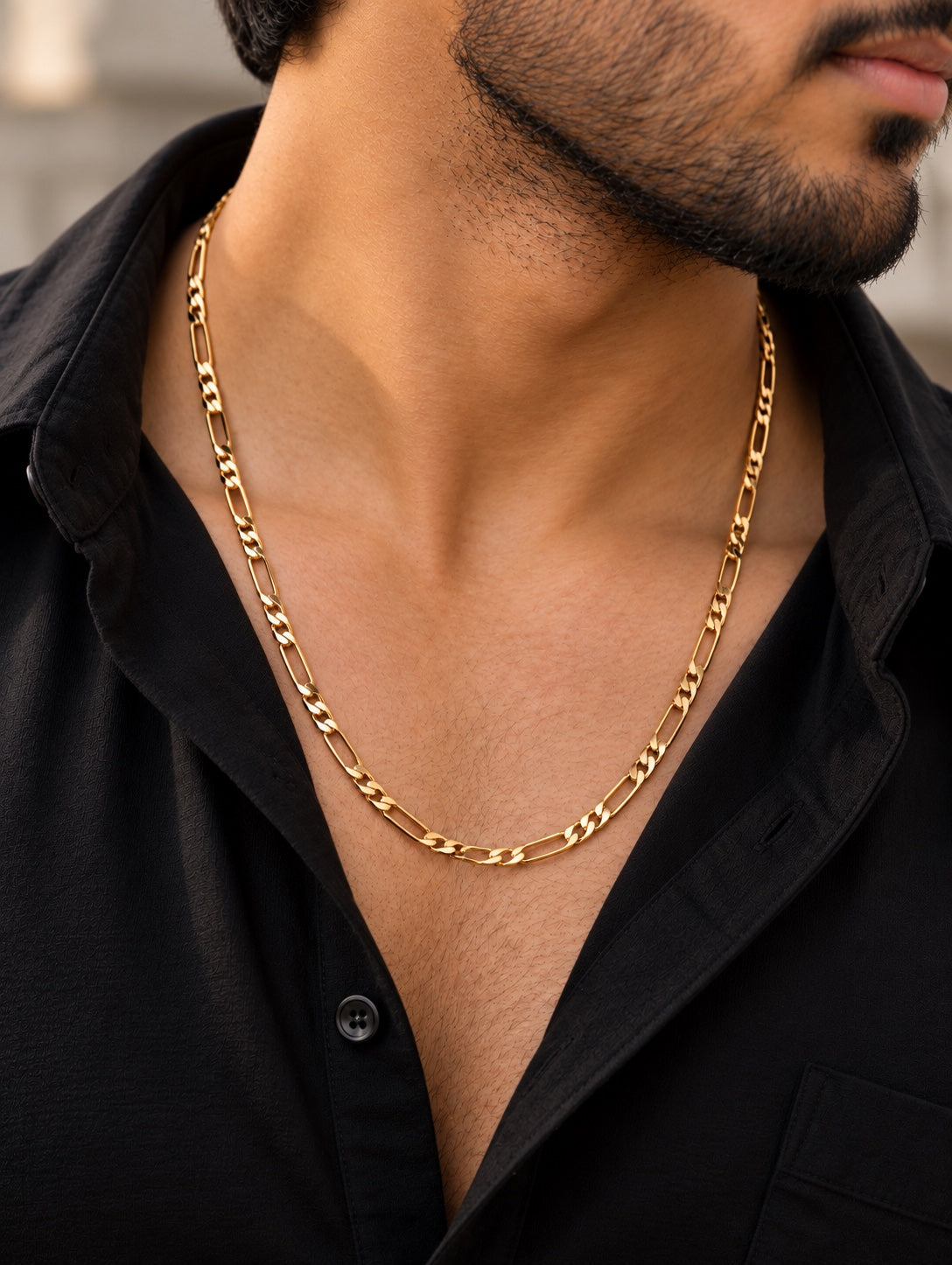 Stylish stainless steel gold chain worn by a man in a black shirt